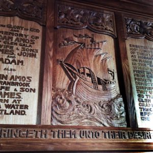Close up ship carved on panel.